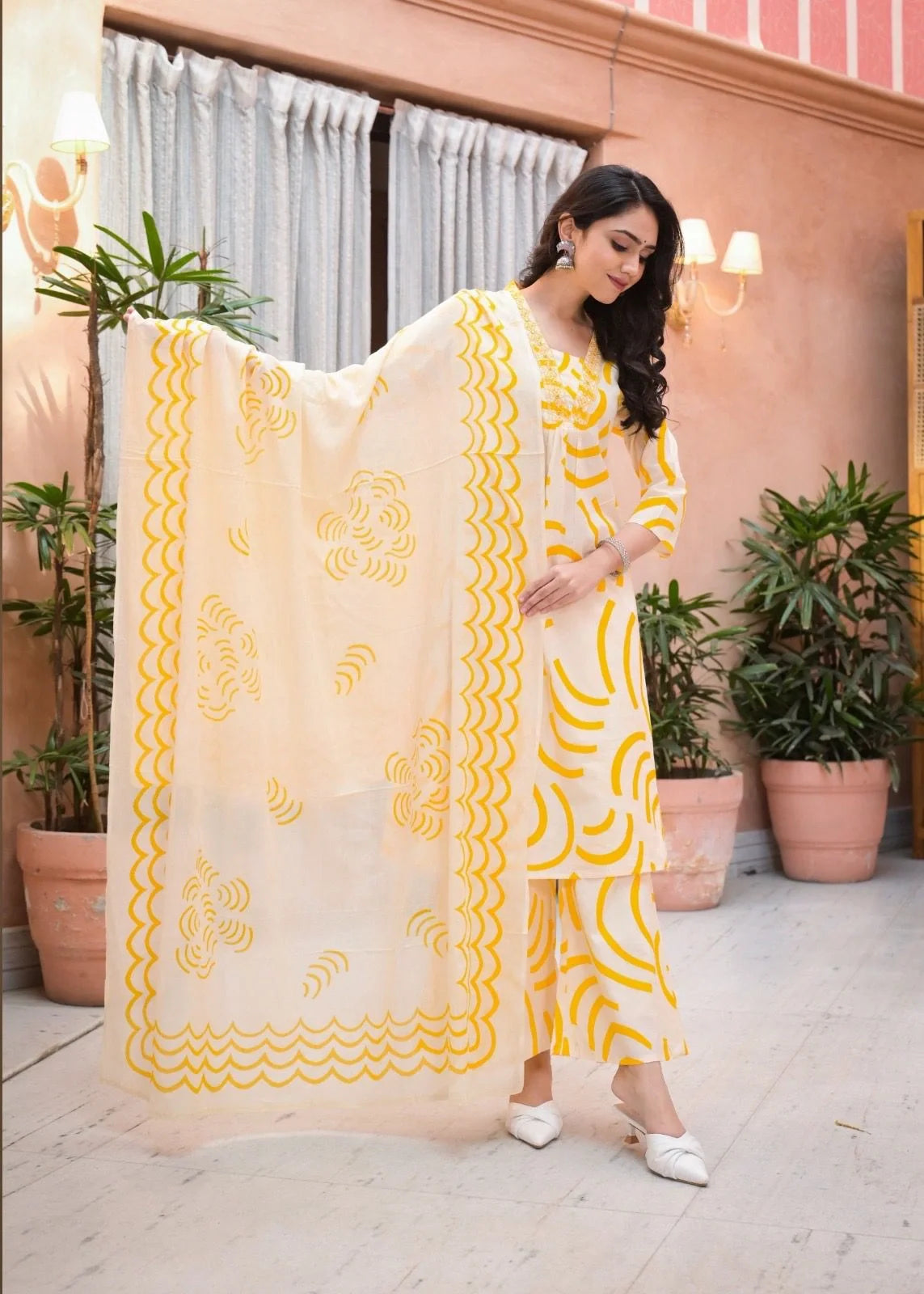 women wearing yellow printed a-line kurta plazzo outfit